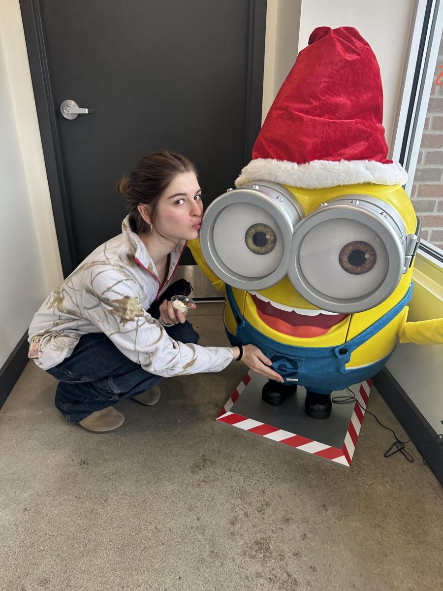 Meghan Pillote poses up next to the minion statue that she found while she got a treat from Tou le Jour. She has always loved minions ever since she can remember. "I watched the Despicable me movie we I was young," Pillote said. "I loved the minion Bob because he was the cutest."