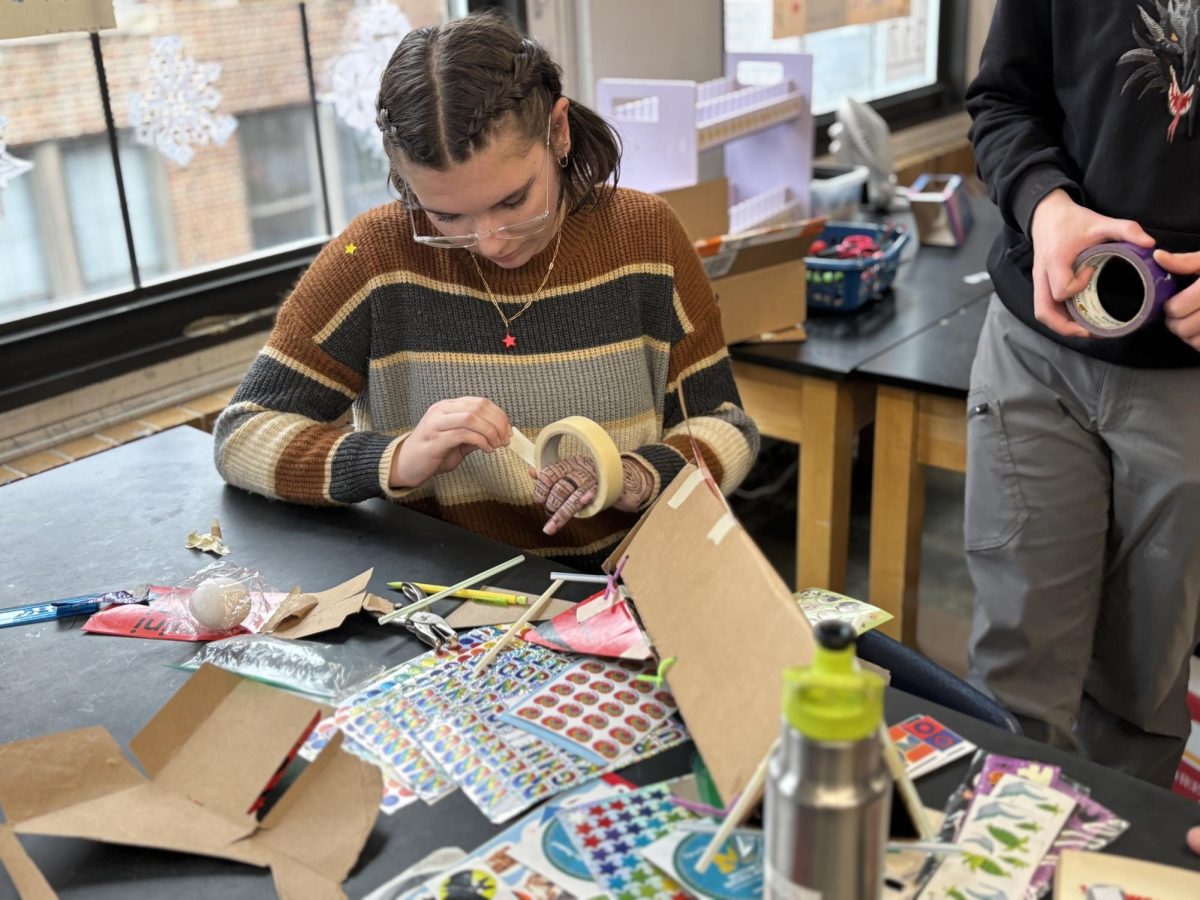 Venus Stolerow works on the last FOS 3 project of the semester. The class’ instructions were to protect an egg after dropping it, using an airbag inflated by the reaction of baking soda and vinegar. “I think it’s really interesting because it’s a different perspective,” Stolerow said. “I’ve only ever done egg drops based on physics.”