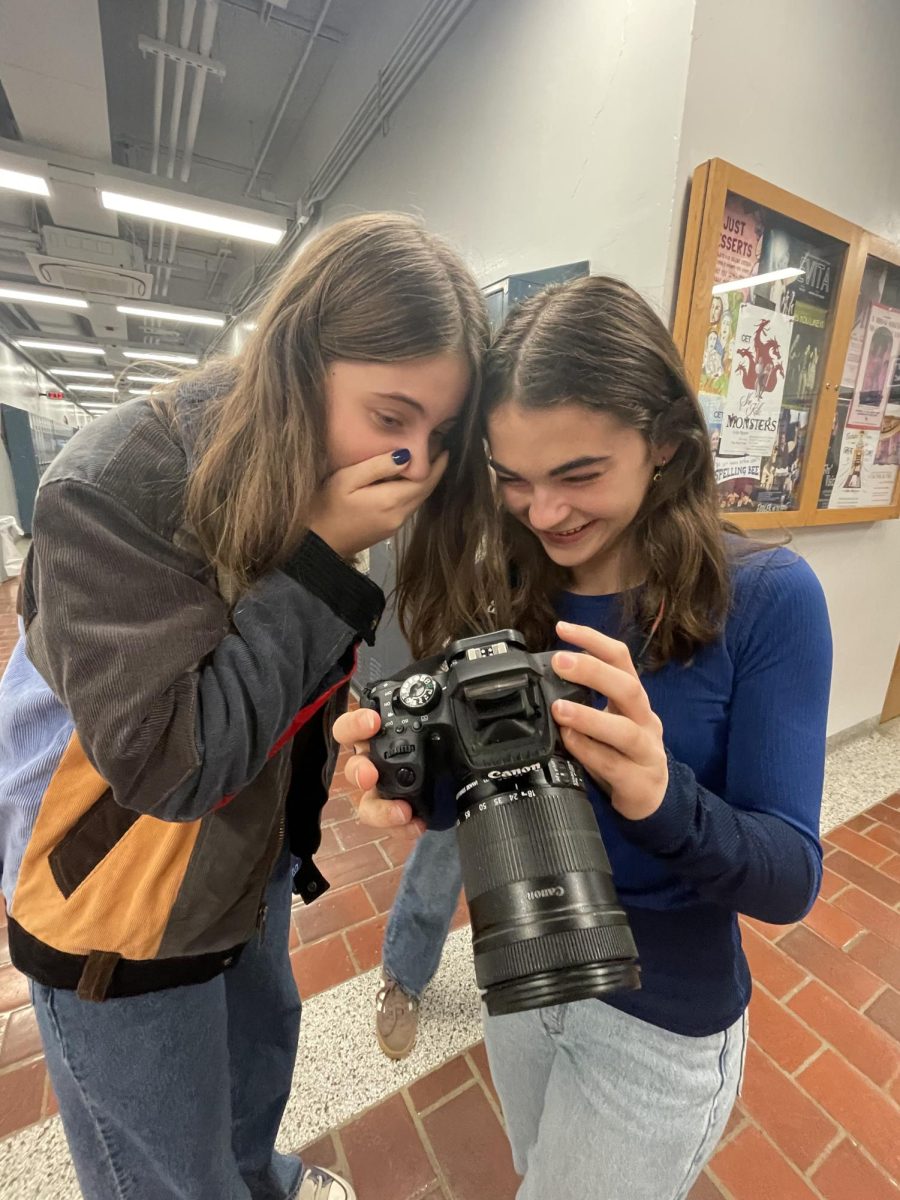 Isla Tharp and Addie McCreadie look at the photos they took on the second floor after sixth block. They were both done with classes for the day and had to wait around after school. “Because of the extra time and Forum Council being canceled, we decided it would be the perfect opportunity to go take some photos,” Tharp said. “I loved seeing Addie Frolicking in the hallways and having fun.”