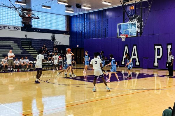 Pioneer player takes his shot at making a basket on the free-throw line during an offensive play.  
