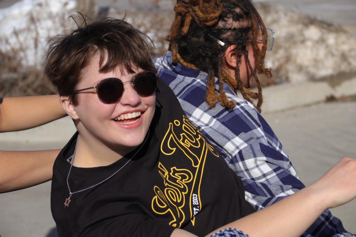 Kai Camara enjoys a sunny afternoon before CET with friends. Kai’s friend was dragging her into the photo to make use of the good lighting and it turned into a fun wrestling game. “When you're outside, you can kind of just be as loud as you want and just have fun without worrying about other people,” Camara said. “In the winter time, I kind of hibernate, but in the summertime, I'm fully me.”