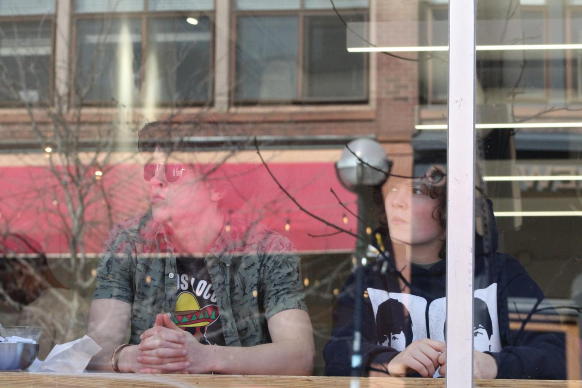 Thomas Radesky sits with a friend at the window counter of Frita Batidos in downtown Ann Arbor. The pair had gotten lunch together, and were enjoying the midday view of the bustling street. "I really like the people watching from this counter," Radesky said. "Sometimes I will wave at someone and they will wave back."