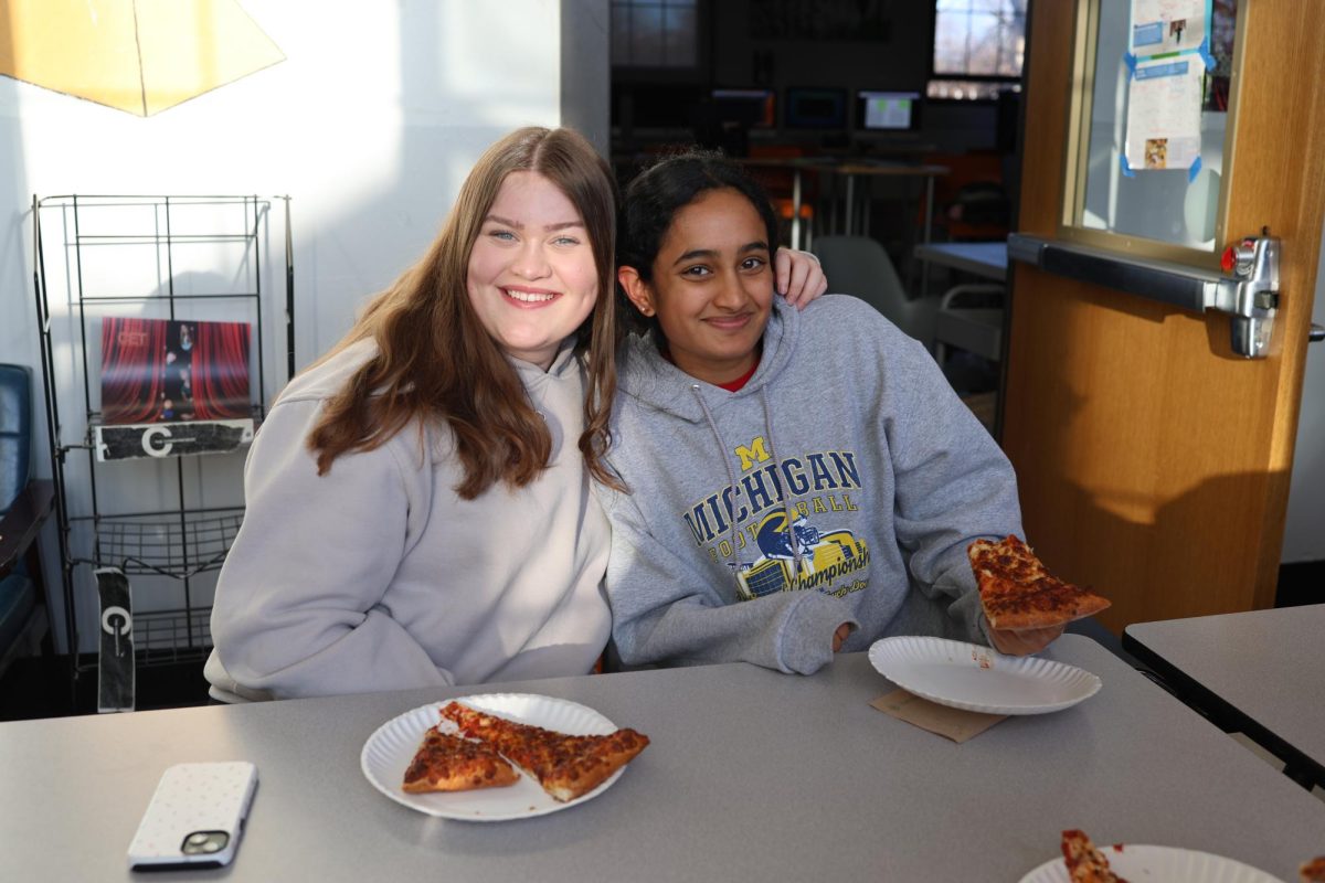 Piper Cooke and Janaki Nallamothu eat pizza during a Communicator production. They love these late nights and being able to help others with their page designs for the magazine. “I love walking around and giving tips to people,” Nallamothu said. “The next Communicator edition is going to be amazing, so get ready!”