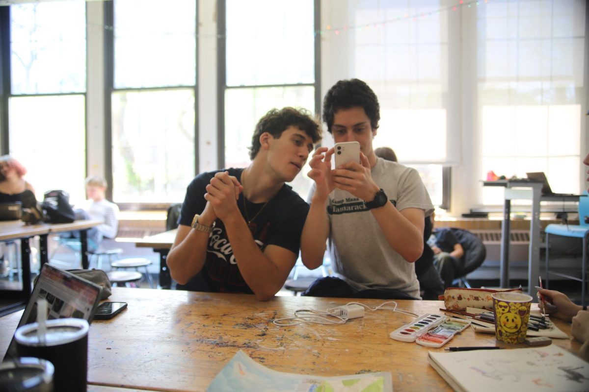 CHS seniors Leo Castilho and Zane Swerdlow scroll through the latest fashion trends on Swerdlow’s phone. They were curious to see what styles are making waves this season.
