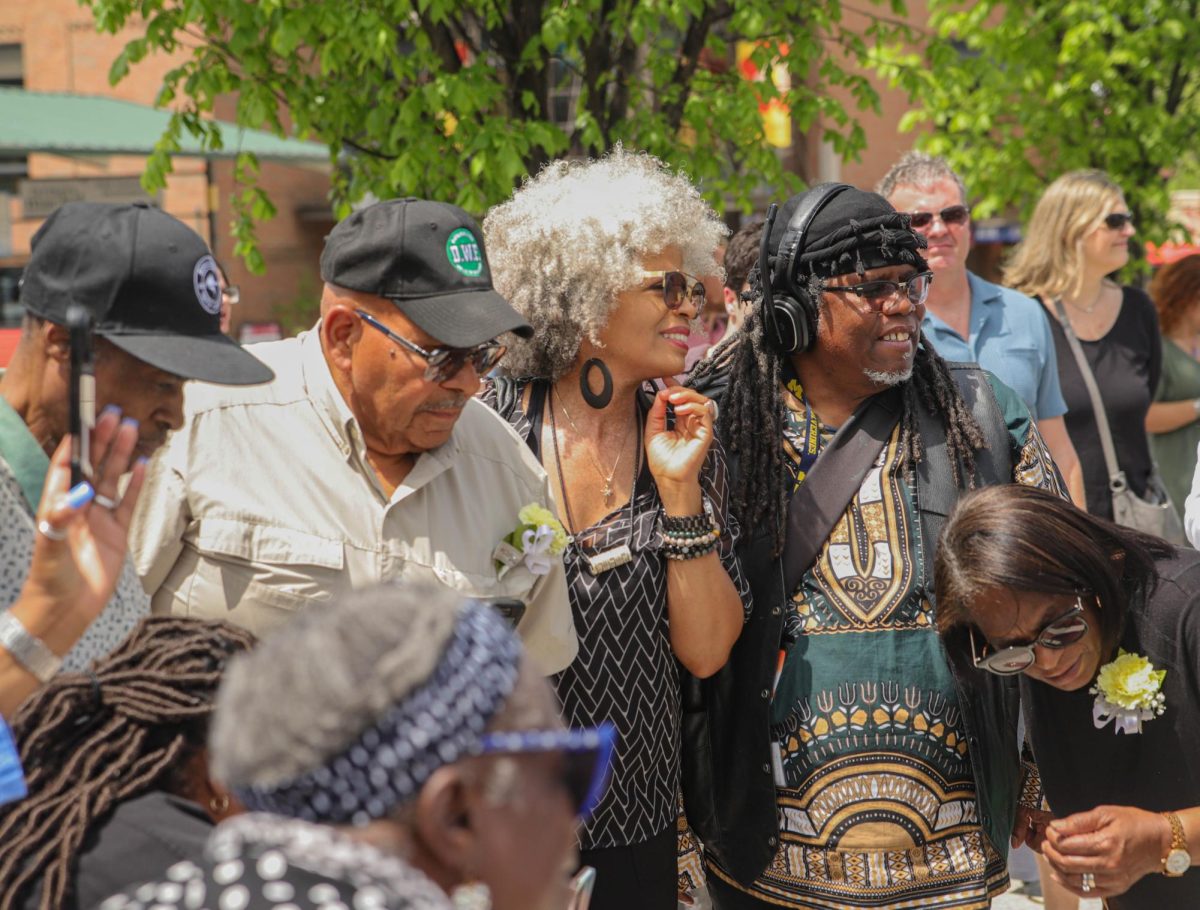 Angela Davis watches the unveiling of the Jones School plaque. Davis was proud of how hard the community worked to put up this marker and uncover pieces of Ann Arbor’s history. “Where we are is the mecca of the Black community, and to have this marker, the ceremony, the veiling on the marker, and everything else that's going on really speaks volumes for everyone,” Davis said. “We are successful. We are family. And that doesn't mean just us, but that means we are family with everyone. Really proud to be a part of this ceremony.”