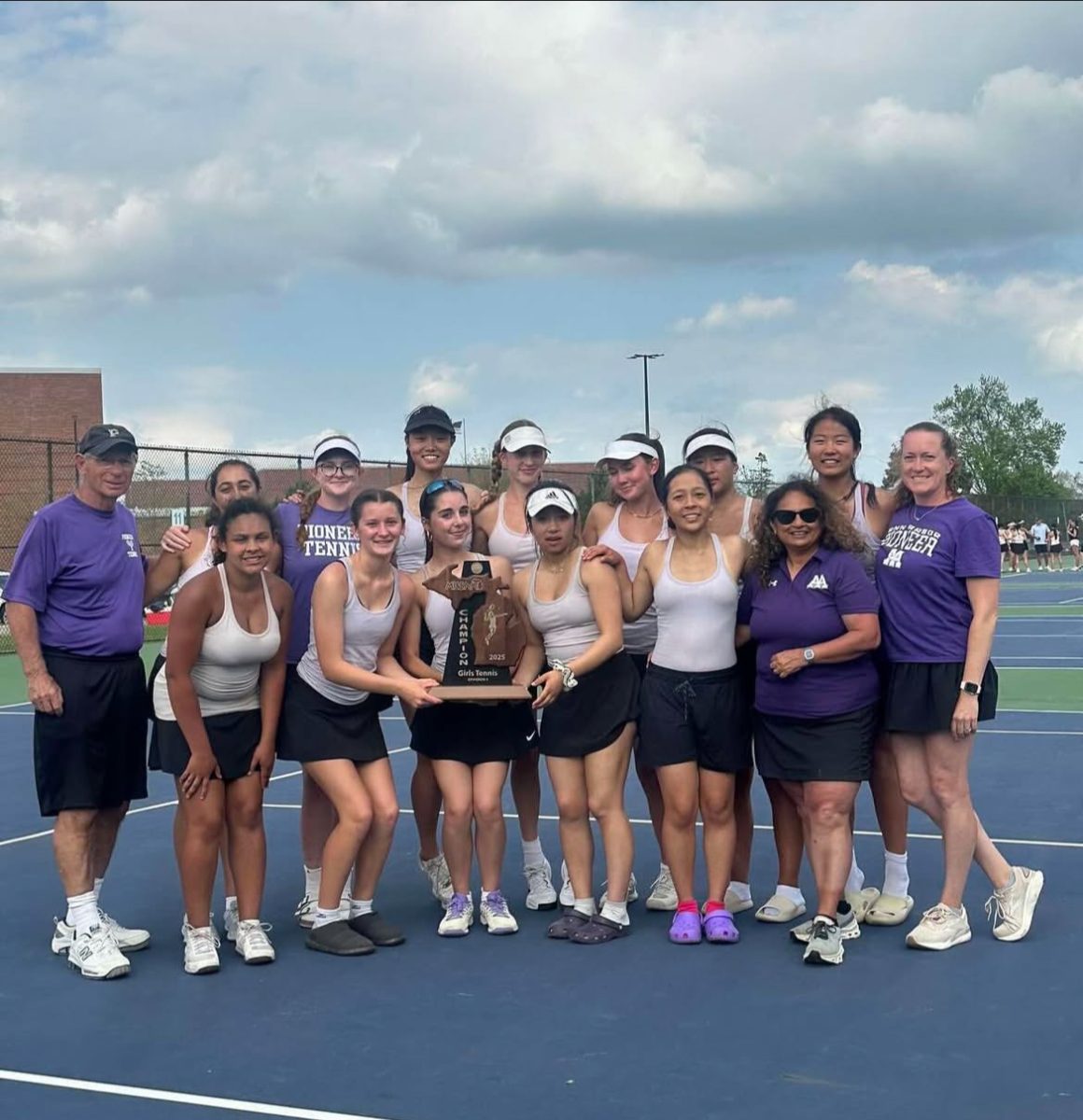 Pioneer High School Girls Tennis holds the regional championship trophy after a long day of matches. 