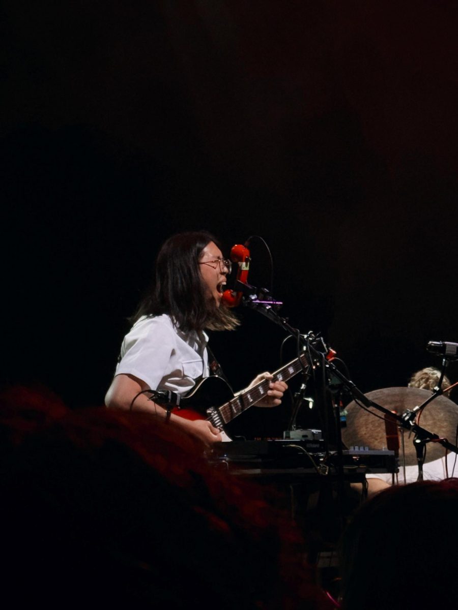 Cameron Lew, sings into a telephone during the final moments of his set.