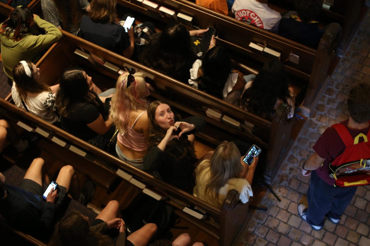 Emma Goblirsch sits in one of Saint Andrews pews for the CHS's annual opening ceremony. The camera caught Goblirsch in just the right moment as she put her hands into a heart for the camera. "I'm just so excited for the upcoming school year" Goblirsch said.