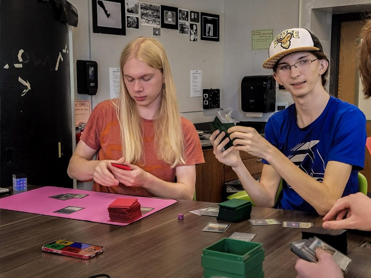 Sophomore Miles Appledorn (left) is playing Magic: The Gathering with his club during lunch. He recently refined his deck, and has been waiting to test it.   "Sorting through all the cards, it's kind of an exercise of the mind," Appledorn said. "There's a lot to go through, and you learn kind of how to filter it down."
