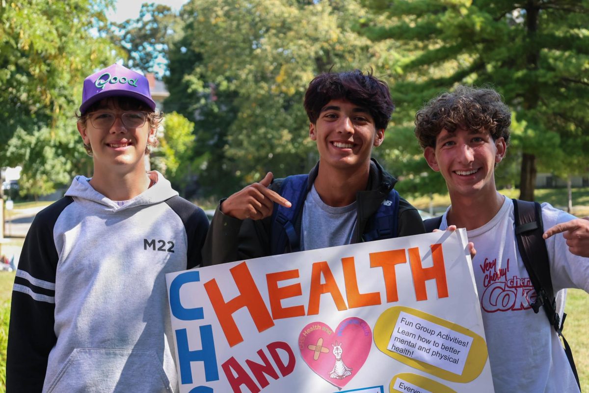Kamari Ronfeldt, Sam Grand and Colin Courage show off their sign. This was the CHS Health and Wellness Club's second year at Club Fair.