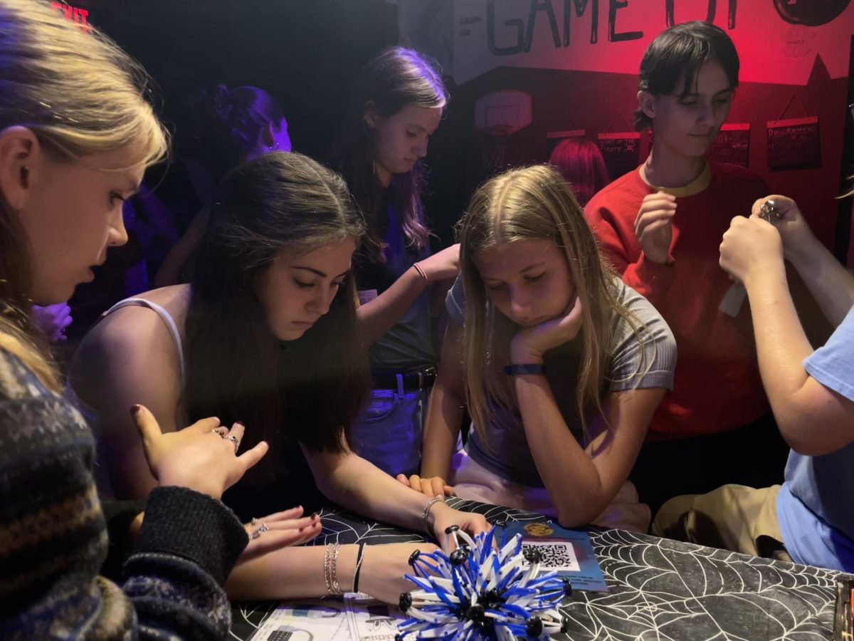 Kiley fourmettes work together to solve a puzzle in the waiting room of Breakout Escape Rooms. The Kiley forum had gathered to do an escape room for Forum Day, a day deticated for forums to spend time together and a longstanding tradition at CHS. "I feel more comfortable talking to people in the forum now." said freshman Kate Honka "We all know each other more, it was so much fun."