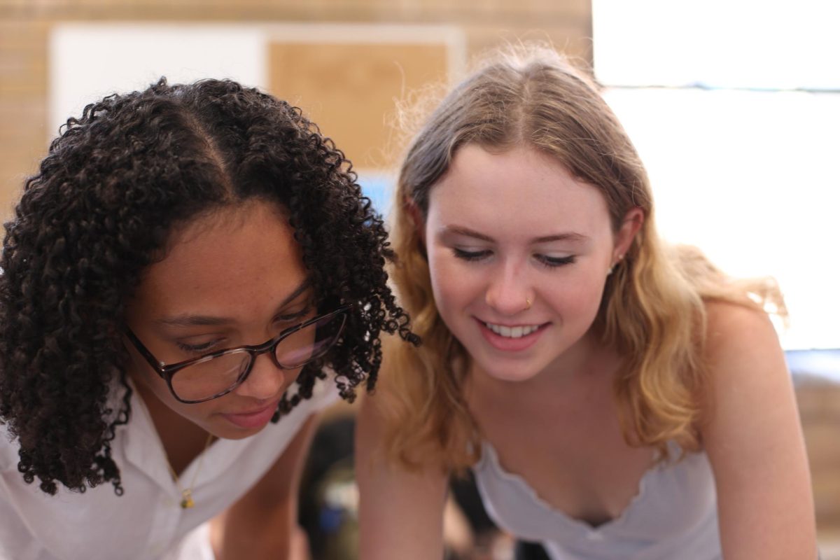 Nylee Harmon and Kennedy McDonald sit on the 3rd floor ledge, looking through the photos the were able to capture throughout the day. For the past week they have talked about taking oppertunities to practice and excel in their photography work. "Camera's really scare me, but I think this year I've been using them a lot more to get the grip of things," McDonald said. "Hopefully over the course of the next few day's I learn some more and can grow."