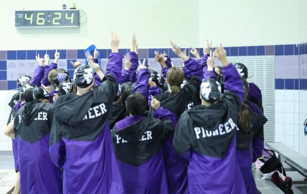 Pioneer does their cheer before their meet against Northville. Each year the captains start the cheer and the girls get progressively louder as the cheer continues.