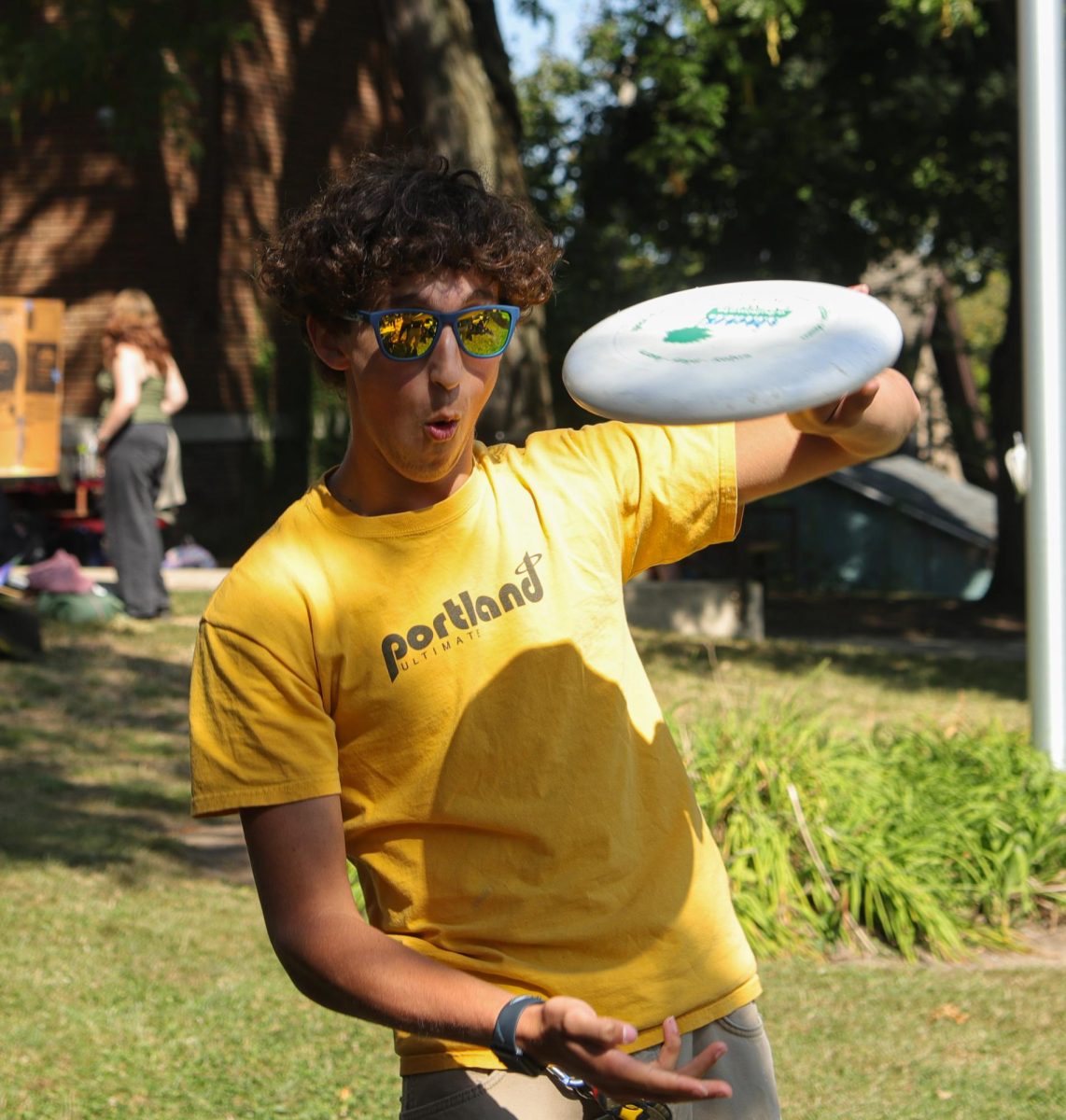 Alden Koschmann shows off his frisbee skills to convince onlookers to join Ultimate Frisbee Club.