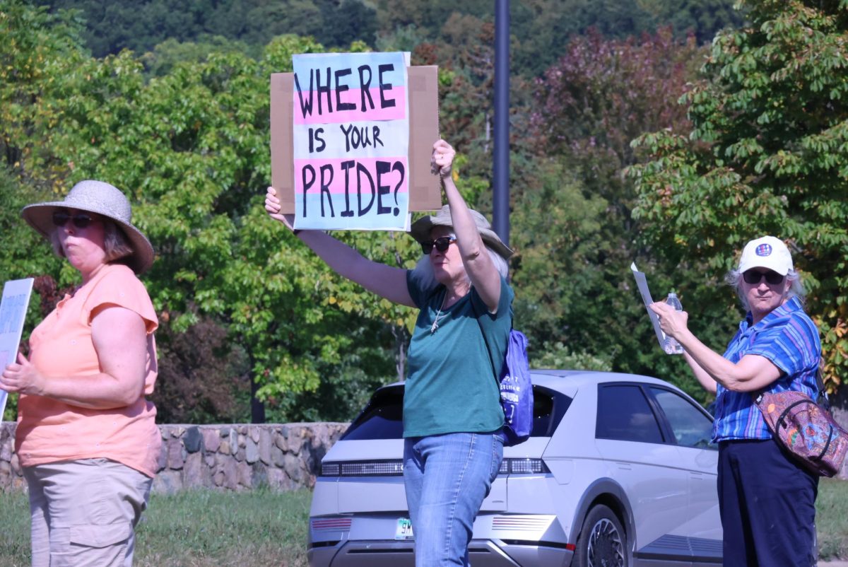 Protestors march down the street with their signs.