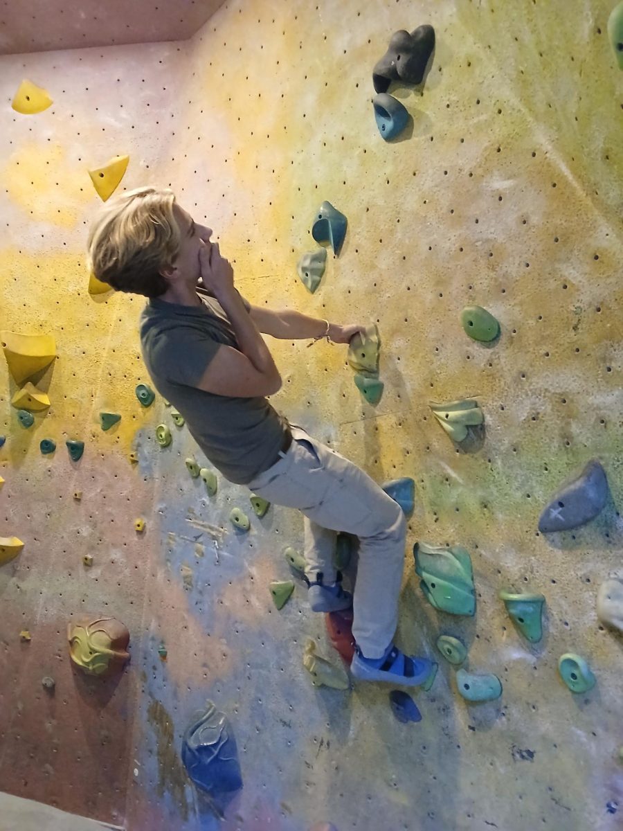 James Dickson climbs at Planet Rock, thinking about how to finish his route. Dickson completed multiple routes before taking a break because his hands hurt. "I enjoy rock climbing because it is a great workout," Dickson said. "It works the muscles you don't normally use."