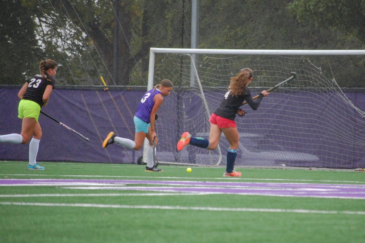 Anna Chomistek pushes through the bitter wind and the rain to honor a Pioneer field hockey team tradition: retro day. Chomistek ran with the ball, wearing a past Pioneer field hockey jersey, demonstrating all the change in progress this program has experienced. "It was really cool seeing all the different jerseys that have been used in the past." Chomistek said. "I thought it was super interesting how they've changed so much from 46 years ago."