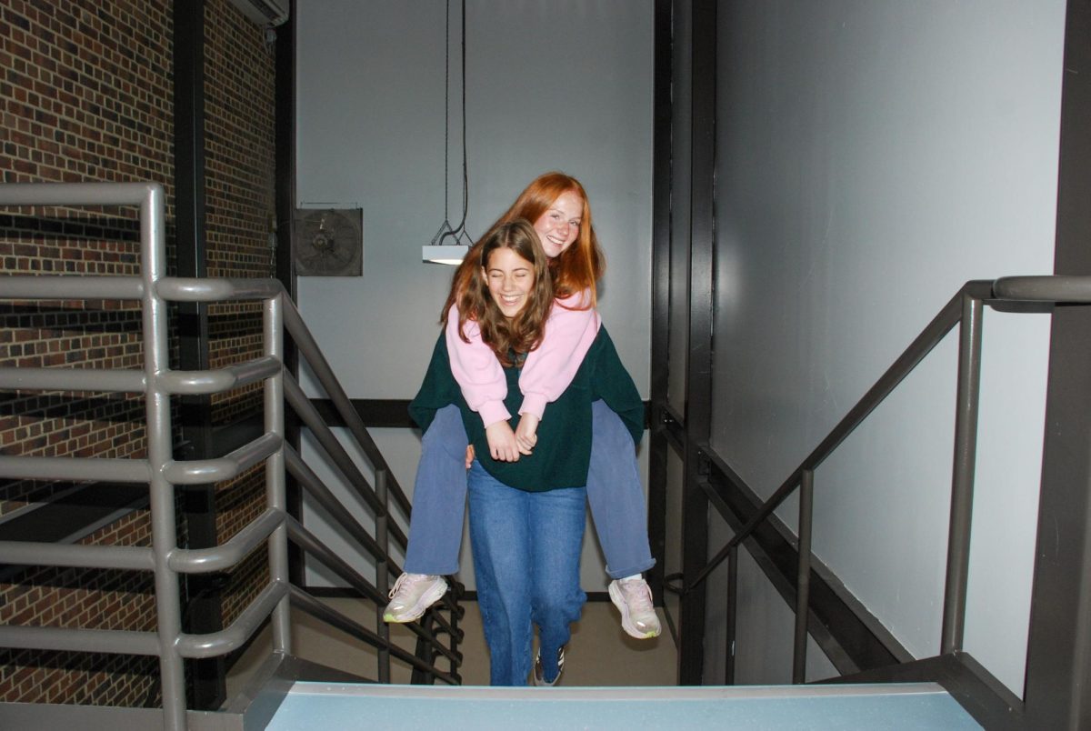 Addie McCreadie gives Maggie Lamb a piggyback ride up the third floor stairs in an effort to prove her strength. Lamb expressed interest in being carried like the backpack that so often weighs her down as she makes her way up the stairs, and McCreadie was happy to test her fitness. "I felt like it was mutually beneficial," McCreadie said. "I got a little workout in, I broke a sweat and Maggie didn't. Really, I think it was a special moment for us both."