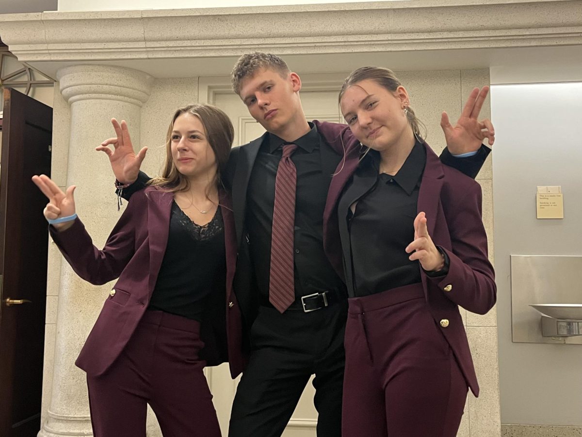Walker Ledbetter (middle) shows up to court matching with Sadie Palay (left) and Ani Ledbetter (right). They didn't plan to coordinate outfits, but it just so happened that all three teammates got similar suits for the mock trial competition. "It was a crazy coincidence," Ledbetter said. "We were all matching which was really fun."