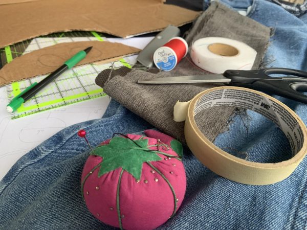 Cardboard, fabric and tools strewn about, Jackson works on his next costume.