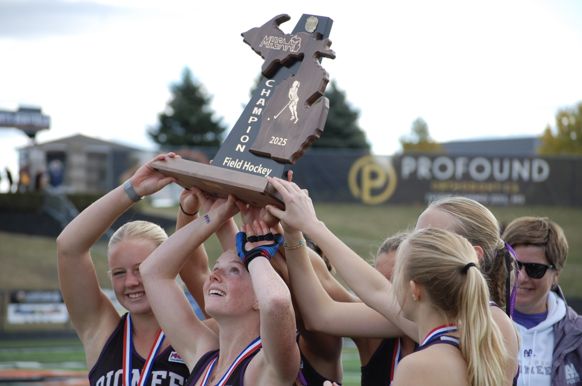 Pioneer Field Hockey seniors lift up their state championship trophy. PFH has won the field hockey State Championship for the fourth year in a row, deeming the senior class unstoppable.