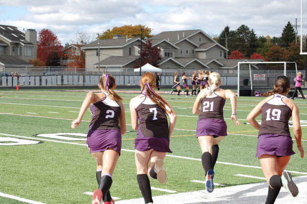 Pioneer Field Hockey (PFH) players rush the field towards the rest of their team. After PFH won the State Championship game with a final score of 2-0.