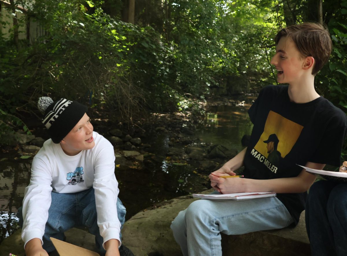 Tobias Kyte and a new friend from Kylie Courtney's FOS I science class explore Traver Creek together for the first time. They were studying the health of the creek and what the next few months of investigating Traver Creek had to come. "For me, going outside and being hands-on is my favorite," Kyte said. "It's just nice to be outside talking to new people."
