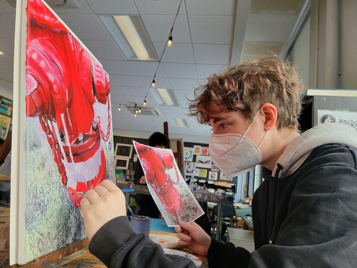 Senior Pluto Meisler is carefully blending reds and adding detail to their fire hydrant painting. It was due weeks ago, but they didn't want to rush the artistic process. "Beth is really nice and lets me turn in all my work late," Meisler said. "I don't know if perfectionism helps or hinders my artistic abilities, but if it doesn't look exactly how I want it to look, I won't stop."
