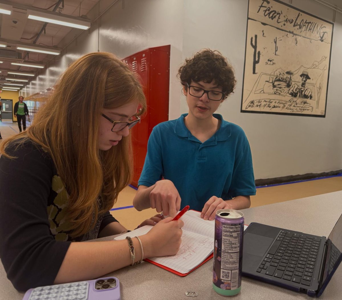 Nic Villamor helps Liliana Amjadi Klass with her algebra work. He enjoys being able to go back to the "easy" work. "After being done with Algebra II for a couple years now," Villamor said. "Its really fun to see what I remember by helping a friend."