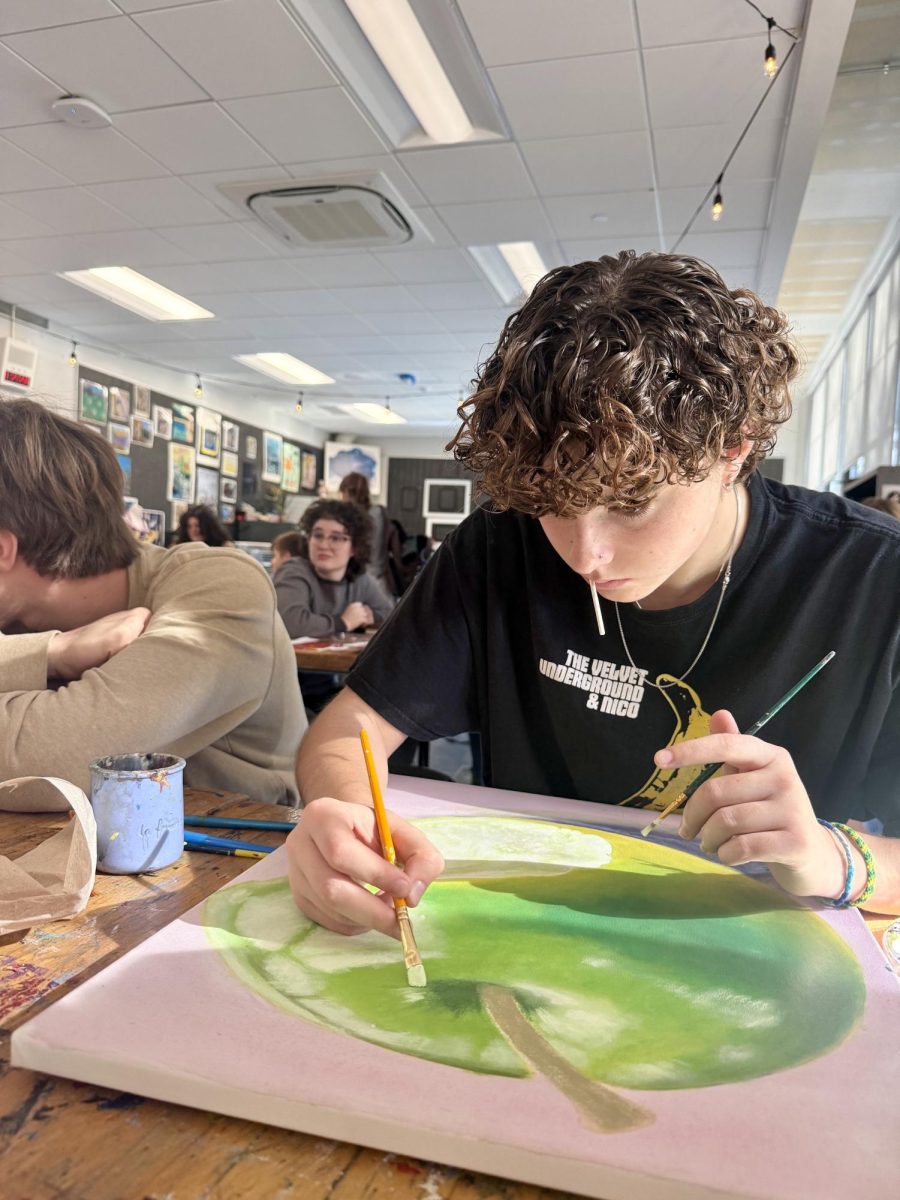 Samantha Magee works on her still life painting in her painting and color theory class. Magee had been working on her painting for weeks to reach perfection. "This was such a fun and challenging project," Magee said. "I really pushed myself but I am so happy with how it turned out."