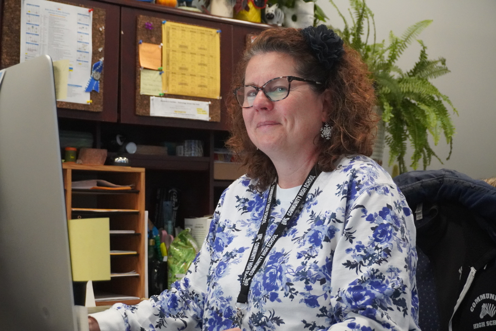 Lisa Durham sits at her desk in the office for a picture.