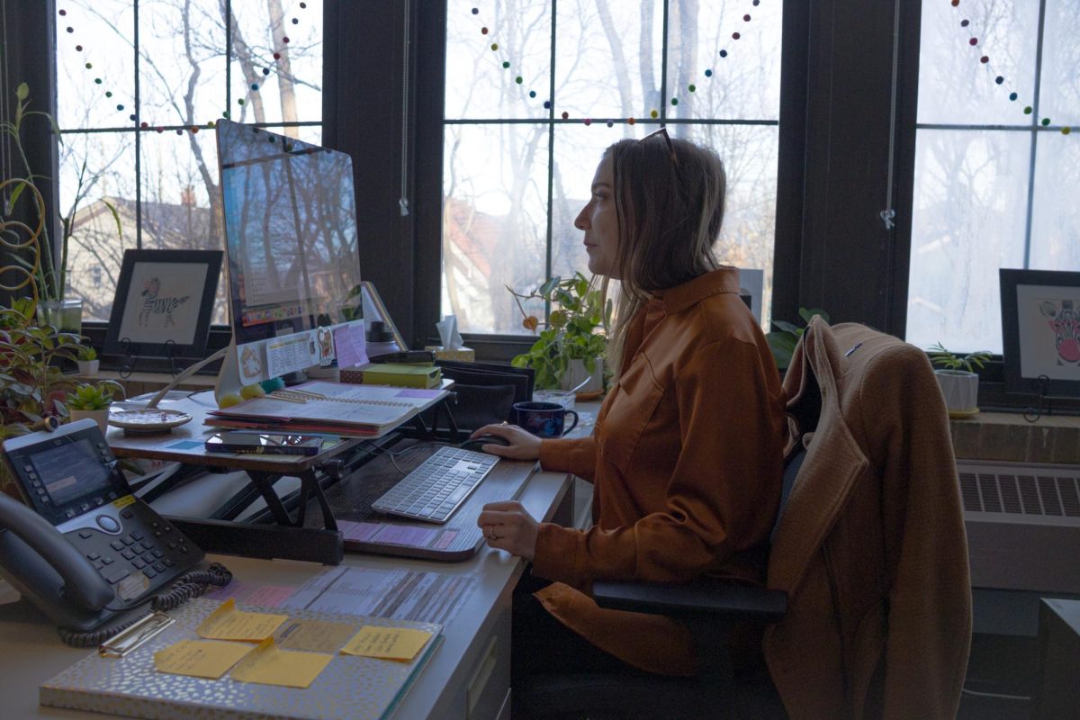 Heather McClure sits in the counselor office doing work.