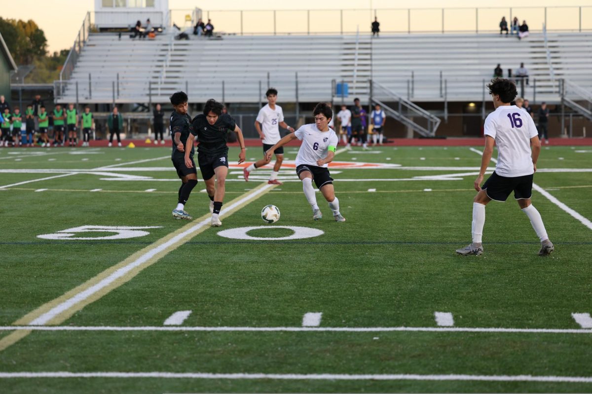 Pioneer’s captain Hans Lechner battles for the ball with Huron’s Christopher Zou in the district final on Oct. 16. It
was a competitive game, with play
moving all over the field. “Huron’s a very
dangerous team,” Sundermann said.
“The final bounce didn’t go our way,
but I’m incredibly proud of our team.”
