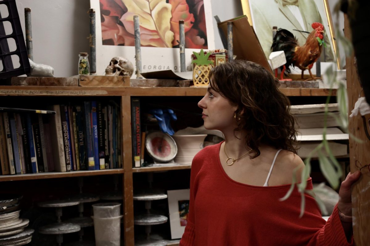 Nina Beals walks through shelves of bits and bobs during her interivew. 