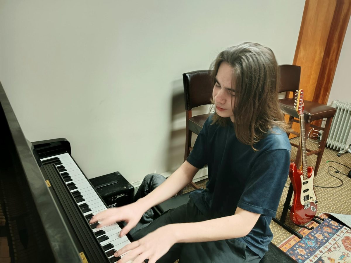 Freshman Max Umbaugh practices the piano after his band practice at Grekin School of Music. Though Umbaugh couldn't remember when he started playing piano, he found the hobby both enjoyable and fulfilling. "I play [piano] because it's something I can do when I'm bored, and it's a fun thing that I can express myself on," Umbaugh said. "I can't imagine a life without it."