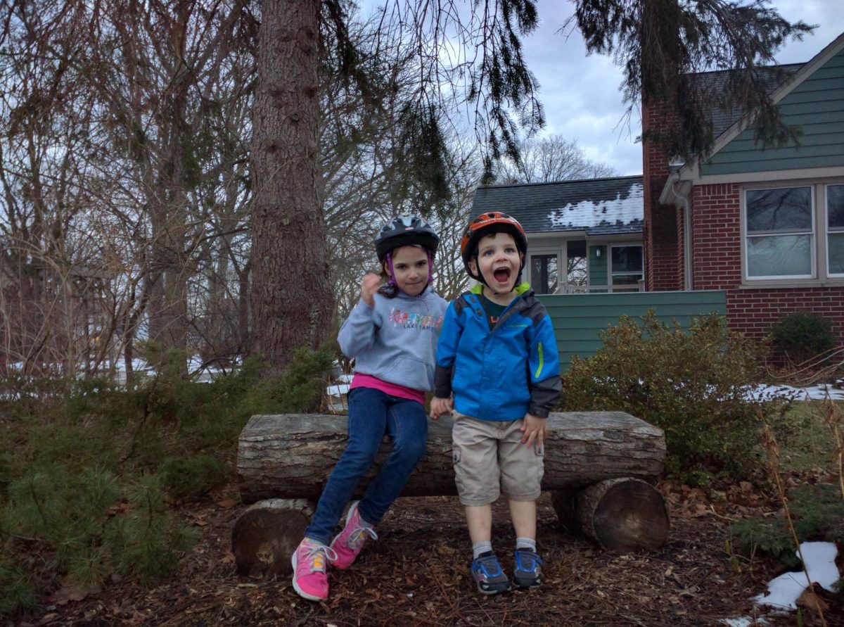 A young Amelia Sandstrom (in jeans) and her brother take a break from a biking adventure.