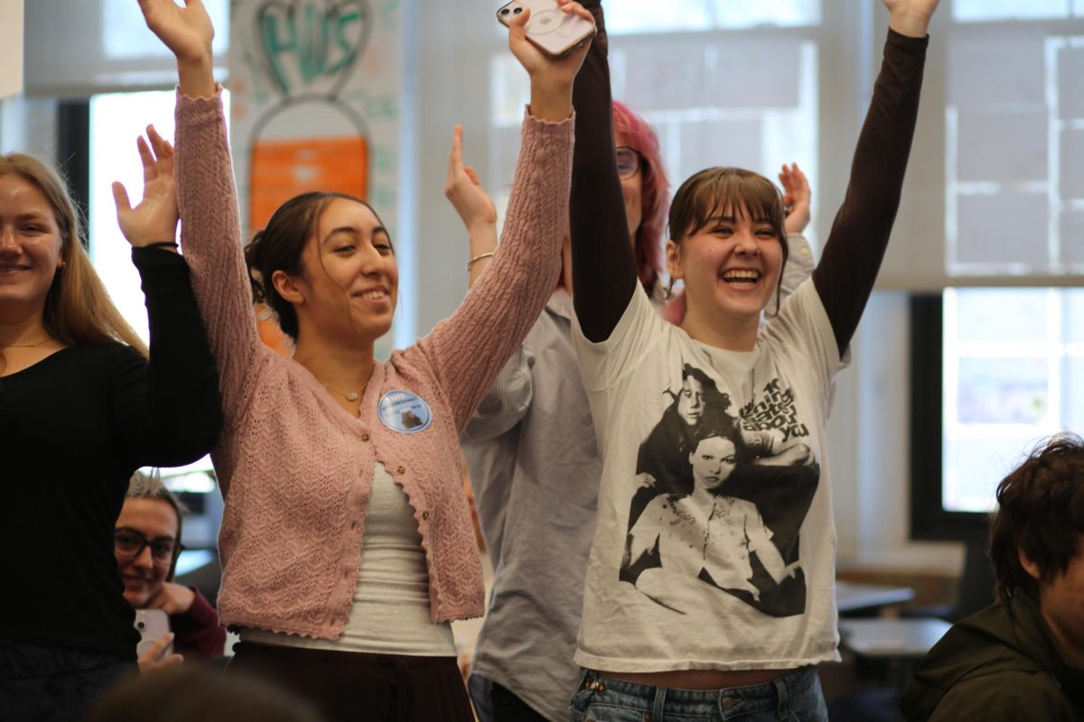 Rosie Matish has her hands up smiling. Matish is doing singing Valentine's at CHS with the other Community Ensemble Theater members, singing "L-O-V-E" by Nat King Cole. "I really love to sing with friends," Matish said. "It's cute to see people's reactions."