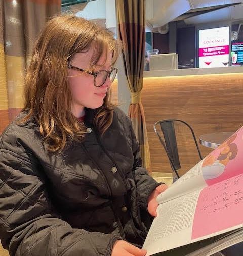 Bea Van Slembrouck flips through the newest edition of The Communicator. She enjoyed looking at all the cool page designs and was looking forward to reading the stories later. "I'm going to read every article in there," Van Slembrouck said. "Everything is always so great."