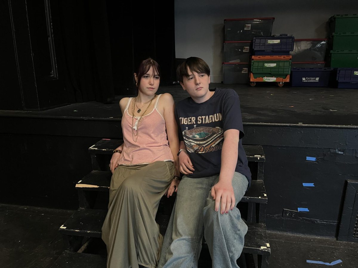 Azalea VanderElzen (left) and Jameson Grice (right) sit on the stairs during a CET rehearsal for "9 to 5: The Musical." The actors sat in the background as they watched Toula Greenawalt perform one of Judy Bernly's songs, "Dance of Death." "The song is really exciting, and a little saucy, per se," VanderElzen said. "I think it's really fun to watch, and we get to add to the dramatic feel of the song and come up and dance at some points."