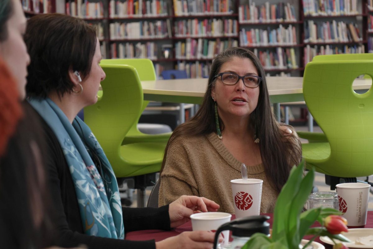 Dean Marci Tuzinsky, along with multiple CHS parents, sit in the library during NAAPID. Pastries and coffee were available from 8-10 a.m. for all parents. "It was great to sit and hear their ideas for the future of the school," Kaylee Gadepalli, a student who attended that morning, said. "I think sometimes high schoolers are embarrassed of their parents being at their school. But everyone I met really wanted to make Community the best it can be."