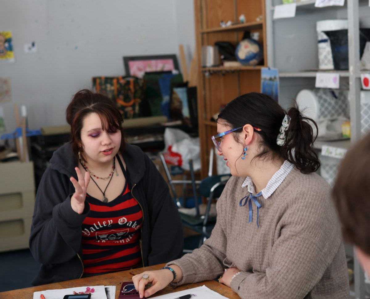 Elinor Freeland and Carolina Hernandez learn how to sign a story in ASL. They had been practicing how to sign words and sentences since the beginning of the school year. "You can see how to use directions in the real world," Freeland said. "This is an actual skill people can use to talk to deaf people."
