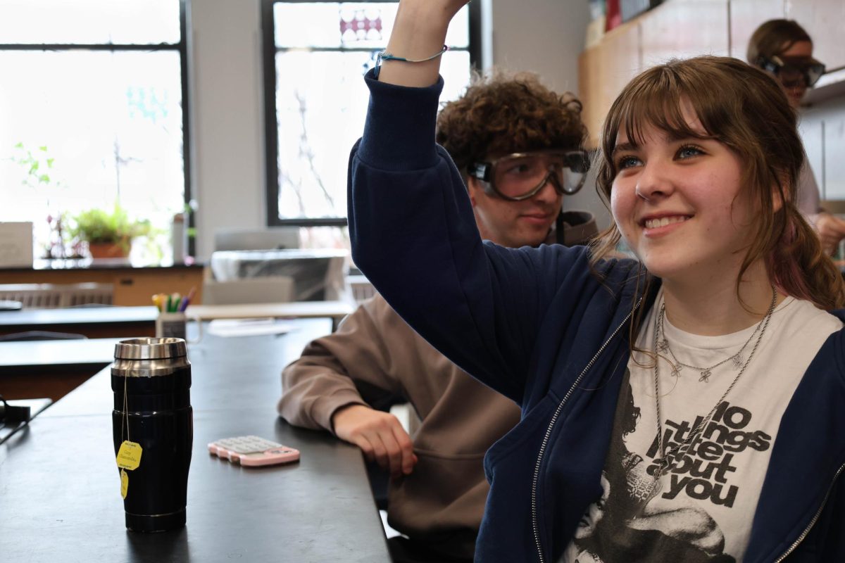 Rosie Matish raises her hand to answer a question during Marcy McCormick's FOS III class.