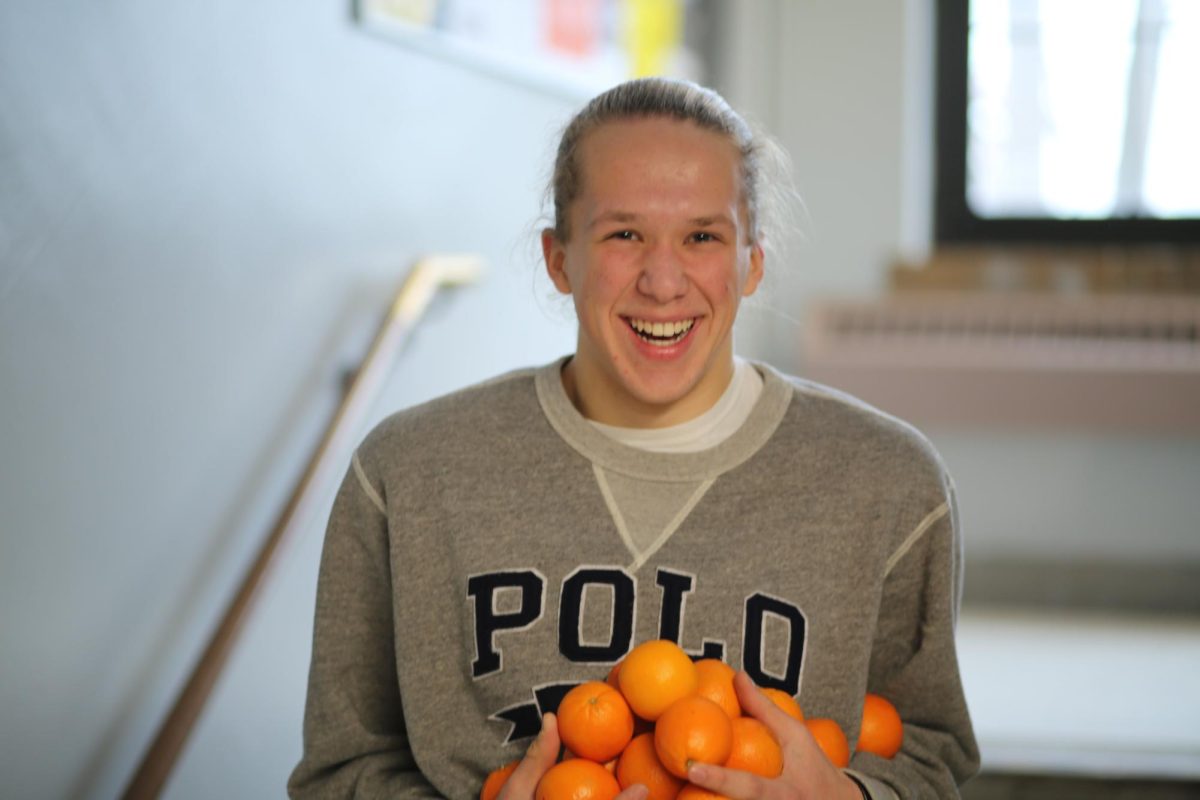 Sam Davidson carries a pile of oranges up to his FOS III class on the third floor. After his second trip down to the first floor, Davidson decided to go for one more round, this time bringing two more students along for the journey. "They were really delicious, I would not have eaten 15 if they weren't so good," Davidson said. "They were really easy to peel as well, everyone else was complaining, but I think they were just jealous."