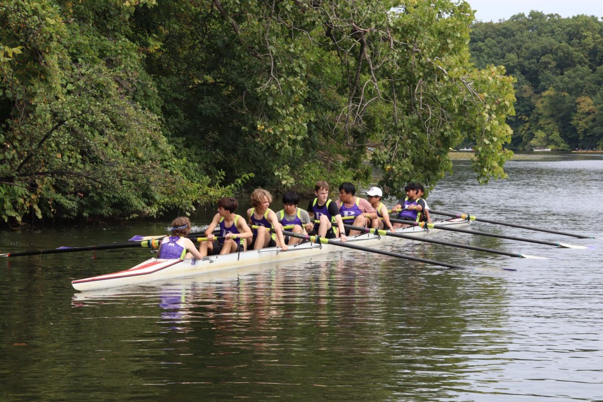 Rowers from Pioneer Crew navigating the water.