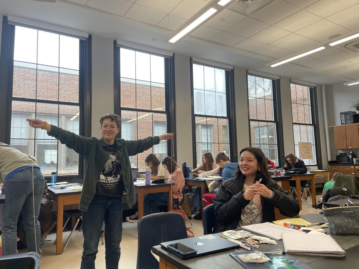 Miriam Haviland and Morgan Chen measure out string for a timeline in FOS 2. They worked hard over two classes to put the project together. "The project involved a lot more math than I expected," Haviland said "I figured out that the string is over three times long as I am tall."