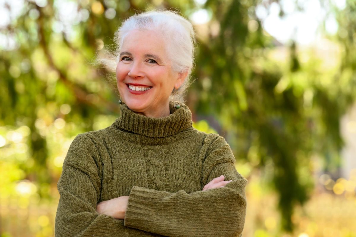 Photo courtesy of the Ann Arbor District Library. Laura Raynor smiles outside for her photo.