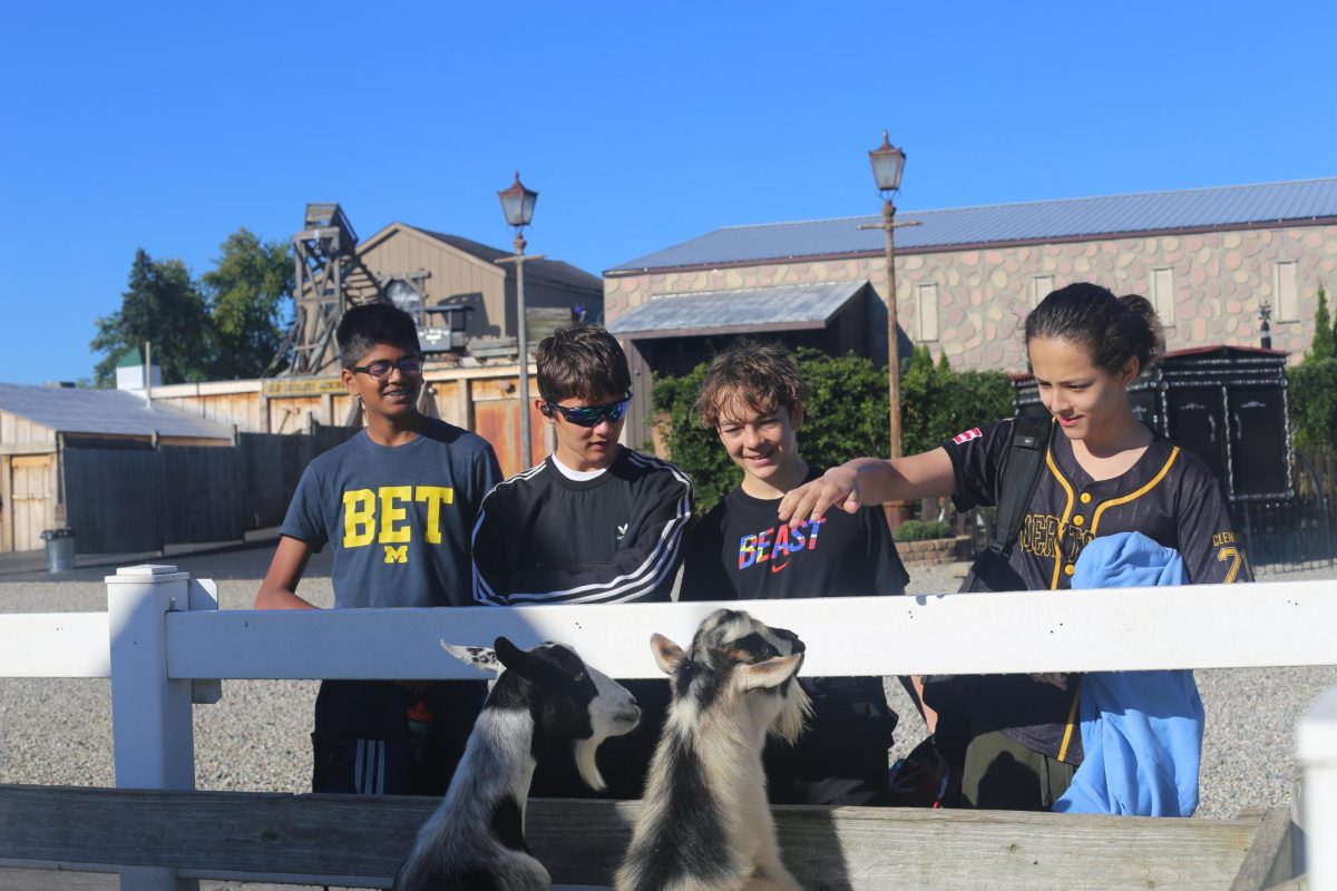 Forumettes of the Johnson Forum participate in their Forum Day activities by petting goats at Wiard's Orchards.