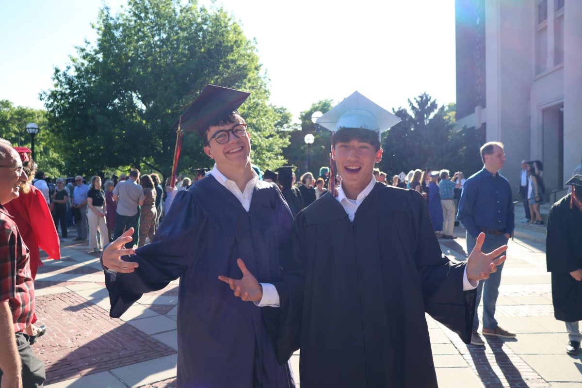 Huck Ellis and Bruno Cifaldi take pictures together in their caps and gowns before going in to Hill auditorium for the CHS graduation ceremony.