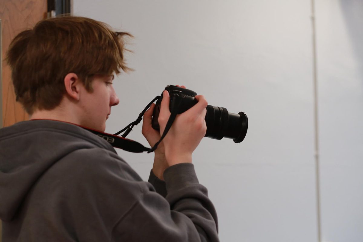 Ian Rae snaps a photo at Community High School. He was learning how to use a camera for the first time. "It was super cool being able to learn how to use a camera," Rae said. "I was never taught how to use one in the first semester, so I'm super excited to challenge myself more this year."