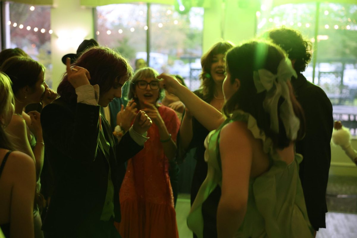 Luca Hinesman and Eva Millwood react as the song "Trap Queen" begins to play.